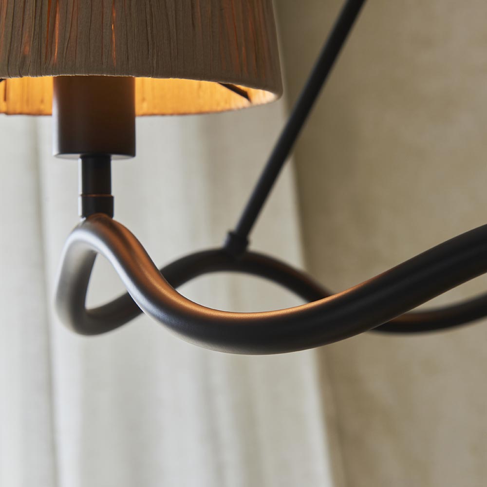 Close-up of the Endon Danemont 3 Light Pendant in black, showing the matt black wave-shaped hoop and one hand-wrapped raffia tapered shade.