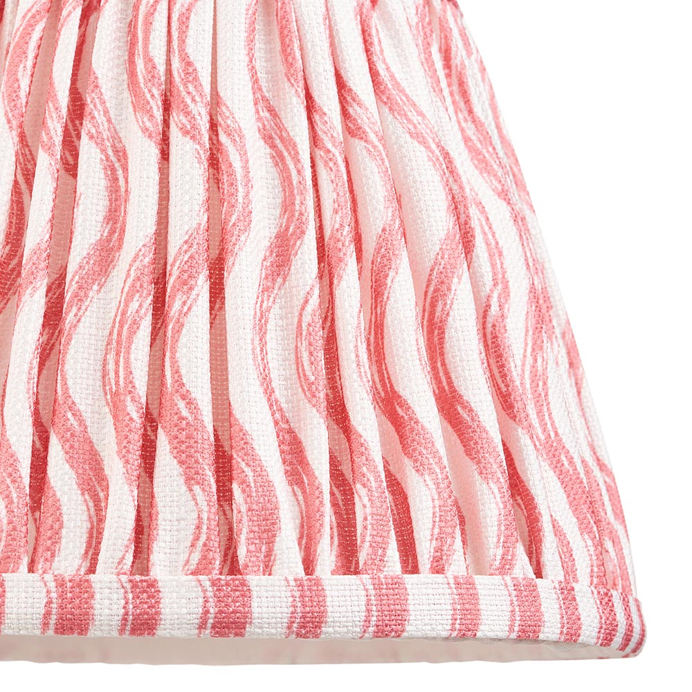 Close-up of the Endon Bevbury Ripple wall light's gathered tapered shade in faux linen with a pink rippling pattern on a white ground.