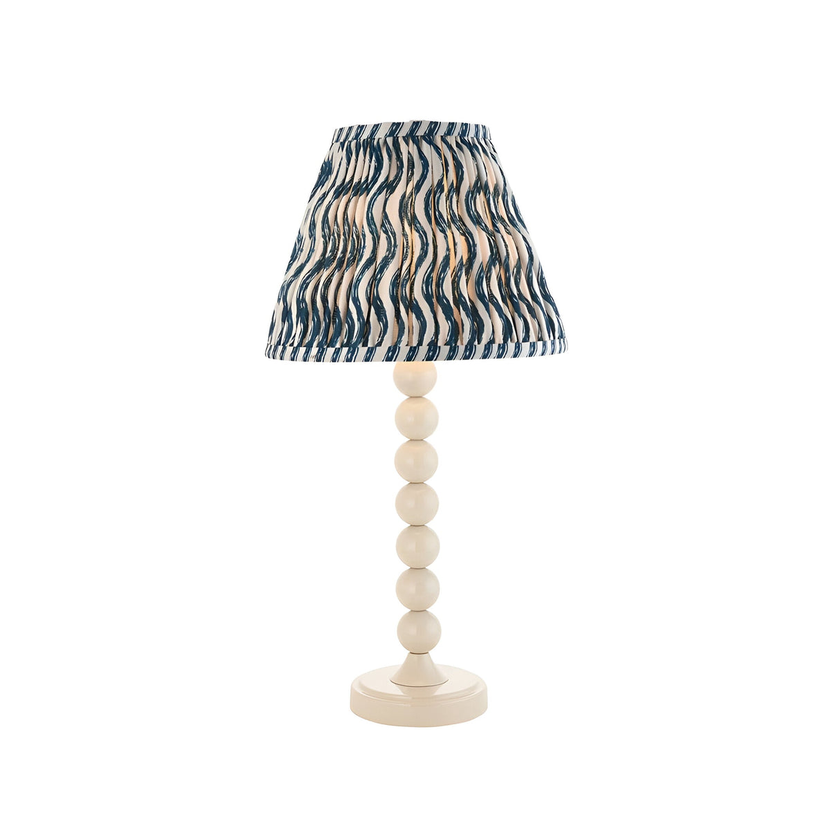 Endon Brenleigh Ripple table lamp with white stacked-sphere base and pleated blue and white wave-print fabric shade, on a plain background.