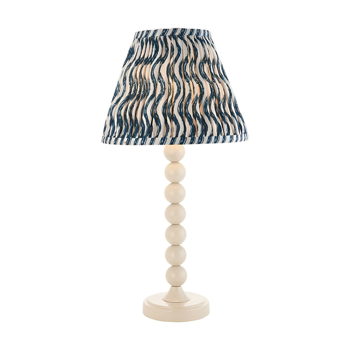 Endon Brenleigh Ripple table lamp with white stacked-sphere base and pleated blue and white wave-print fabric shade, on a plain background.