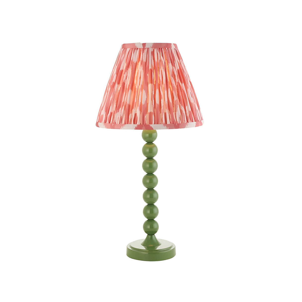 Endon Brenleigh Ikat table lamp with a green stacked-sphere metal base and pink pleated ikat faux silk shade on a white background.