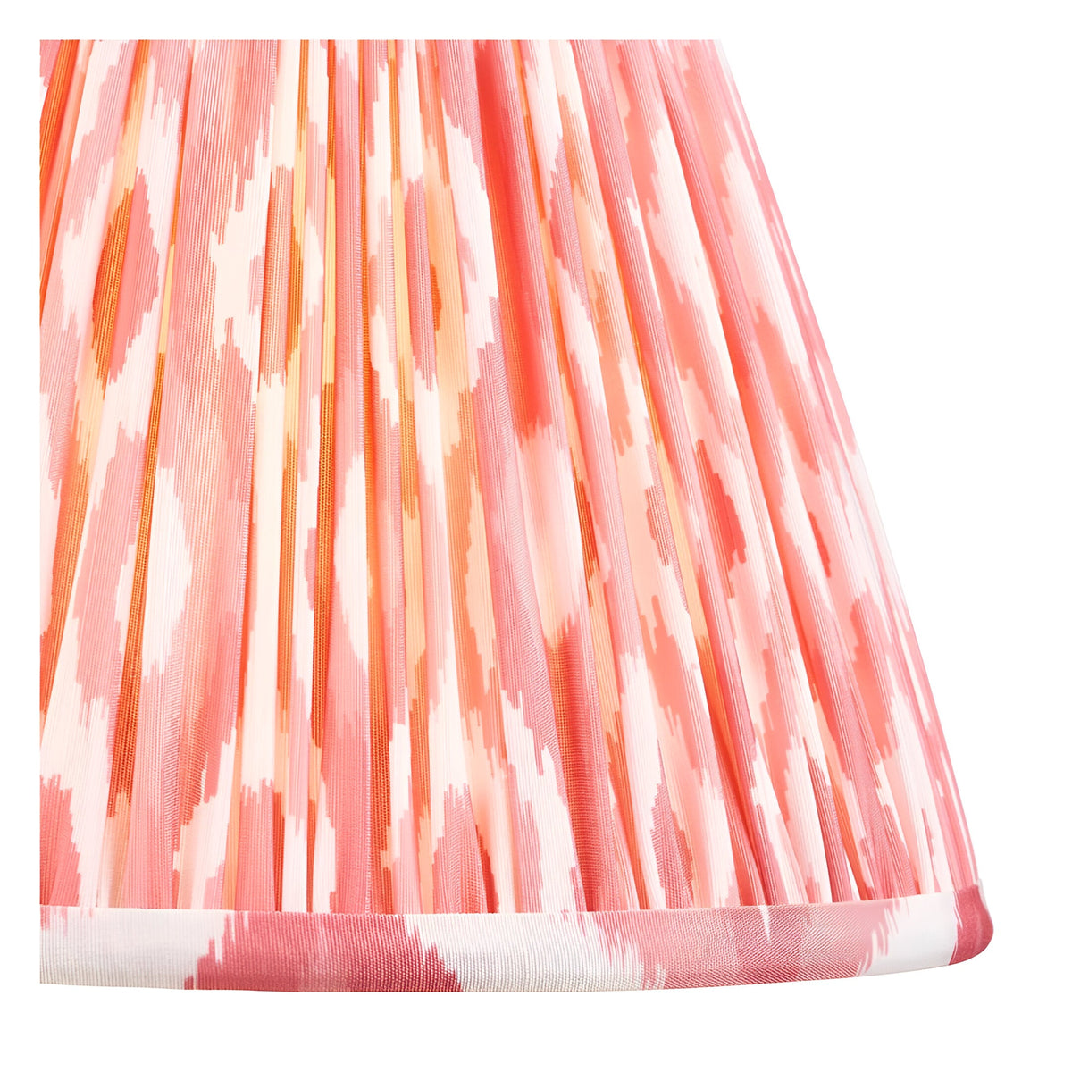 Close-up of the Endon Brenleigh Ikat table lamp's hand-pleated faux silk shade in pink, coral and cream Ikat print with taped edge detailing.