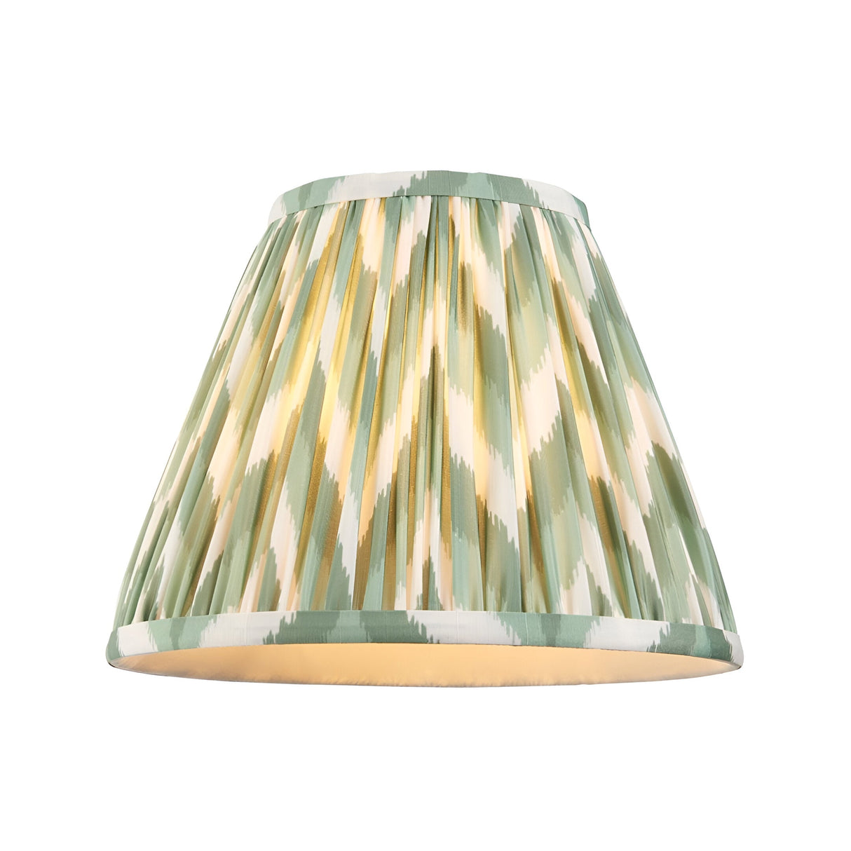 Endon Brenleigh Zigzag pleated faux silk lampshade in green and cream ikat print with taped edges, shown illuminated on a plain white background.