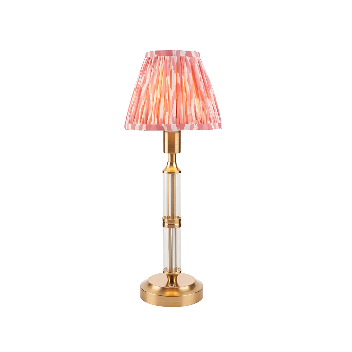Endon Carlwood LED table lamp with brushed brass base, clear acrylic column and handmade pleated coral pink Ikat shade on a white background.