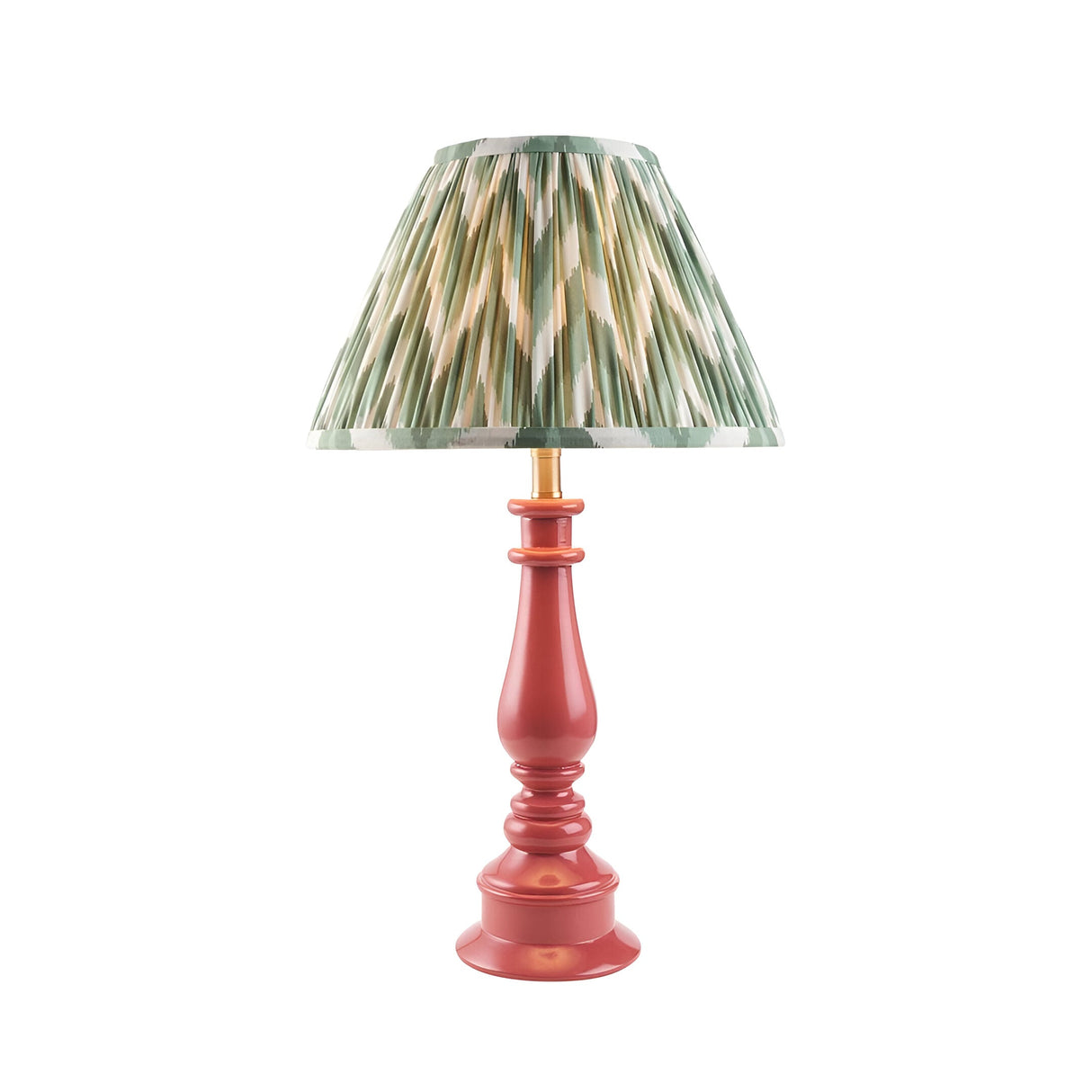 Endon Carlworth Zigzag table lamp with turned pink resin spindle base, brass holder, and pleated green zigzag faux silk shade on a white background.