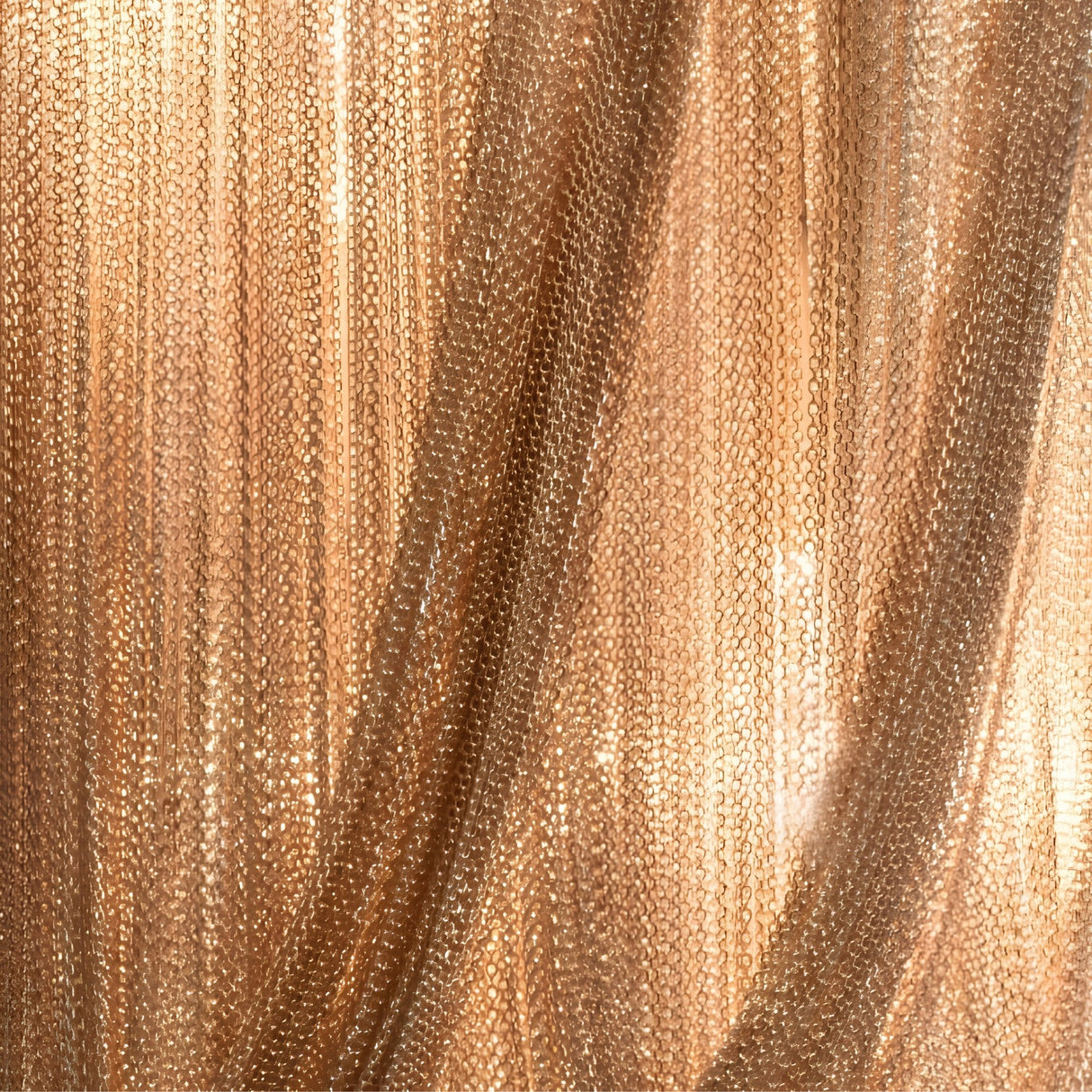 A close-up of the Mireya 6 Light Metal Chain Veil Wall Light in Champagne shows shimmering gold chains hanging in parallel rows, creating a reflective, textured curtain effect—a striking example of sculptural wall decor.