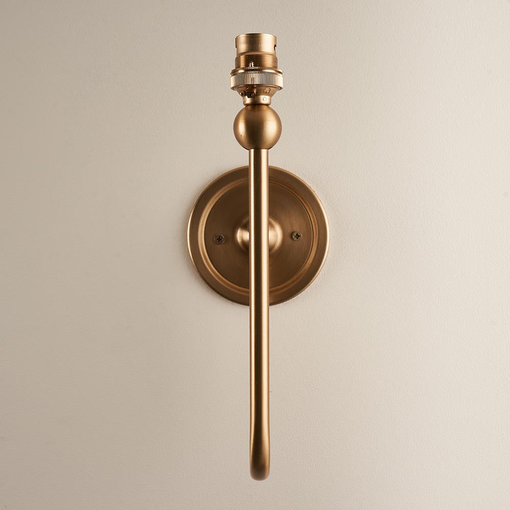 Endon Cliffleigh Leaf II wall light base in brushed aged brass, showing the long arm, round back plate and B22 lamp holder against a pale background.