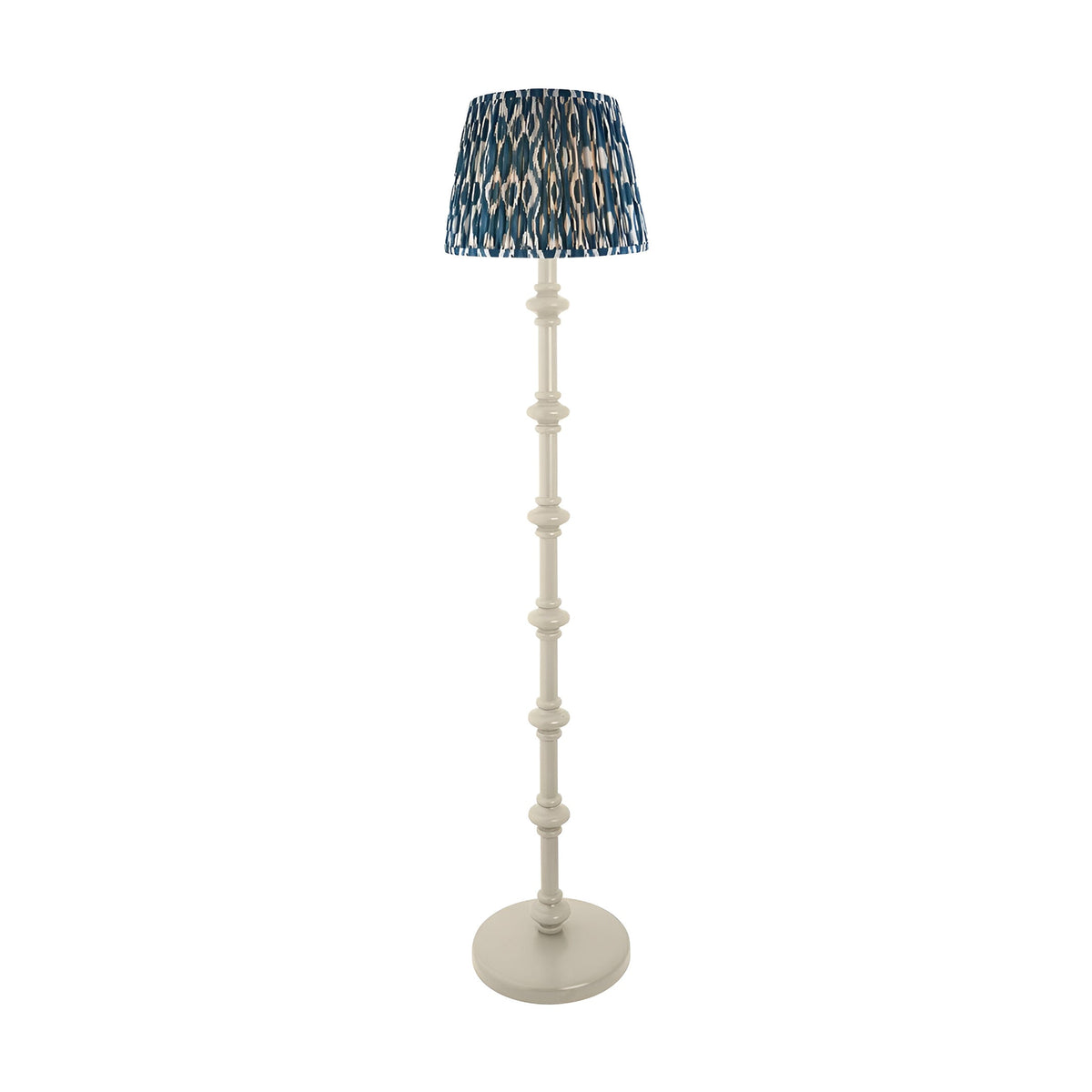 Endon Bevbury floor lamp with white turned spindle wood base and blue Ikat pleated fabric shade, shown on a plain white background.