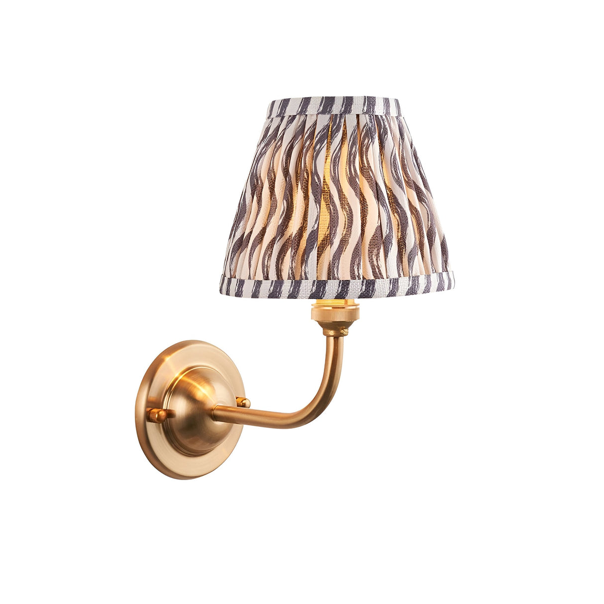 Endon Brackdale Ripple wall light in brushed aged brass with a pleated tapered shade in pearl grey faux linen ripple print, on a white background.