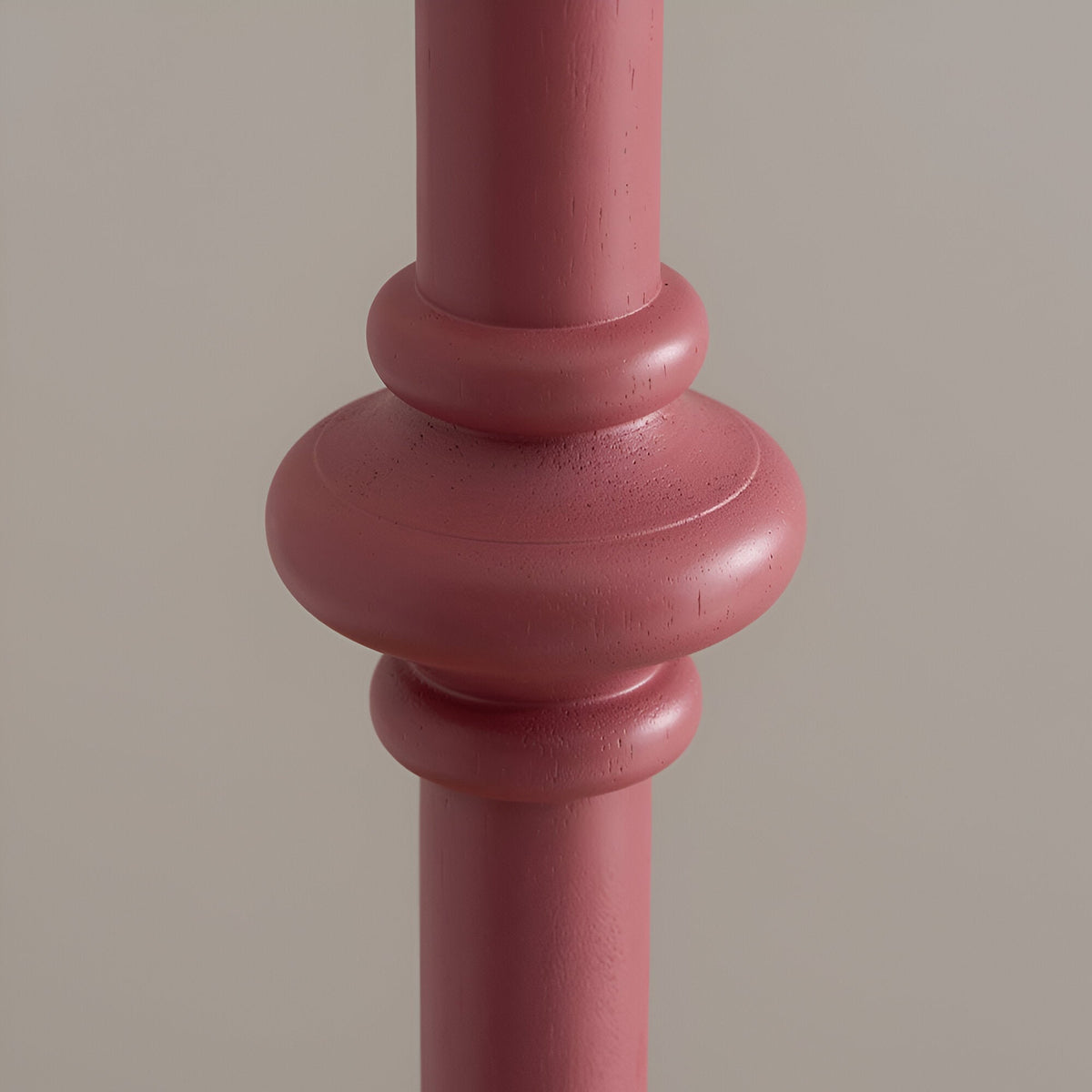 Close-up of the Endon Bevbury Zigzag floor lamp's hand-turned wooden spindle base in pink clay satin finish against a neutral background.