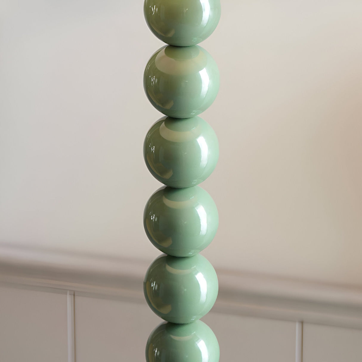 Brenleigh Zigzag Floor Lamp base close-up showing glossy green stacked sphere column design against a plain light background.