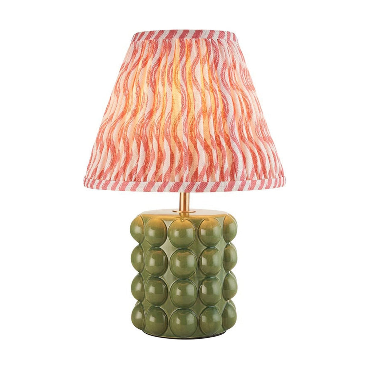 Amberley Ripple table lamp with a green ceramic bobble base, brass stem, and pink and orange wavy-pattern fabric shade on a white background.