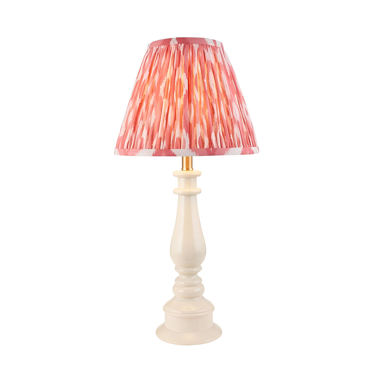 Endon Carlworth Ikat table lamp with turned almond gloss resin spindle base and pleated coral ikat faux silk shade on a plain white background.