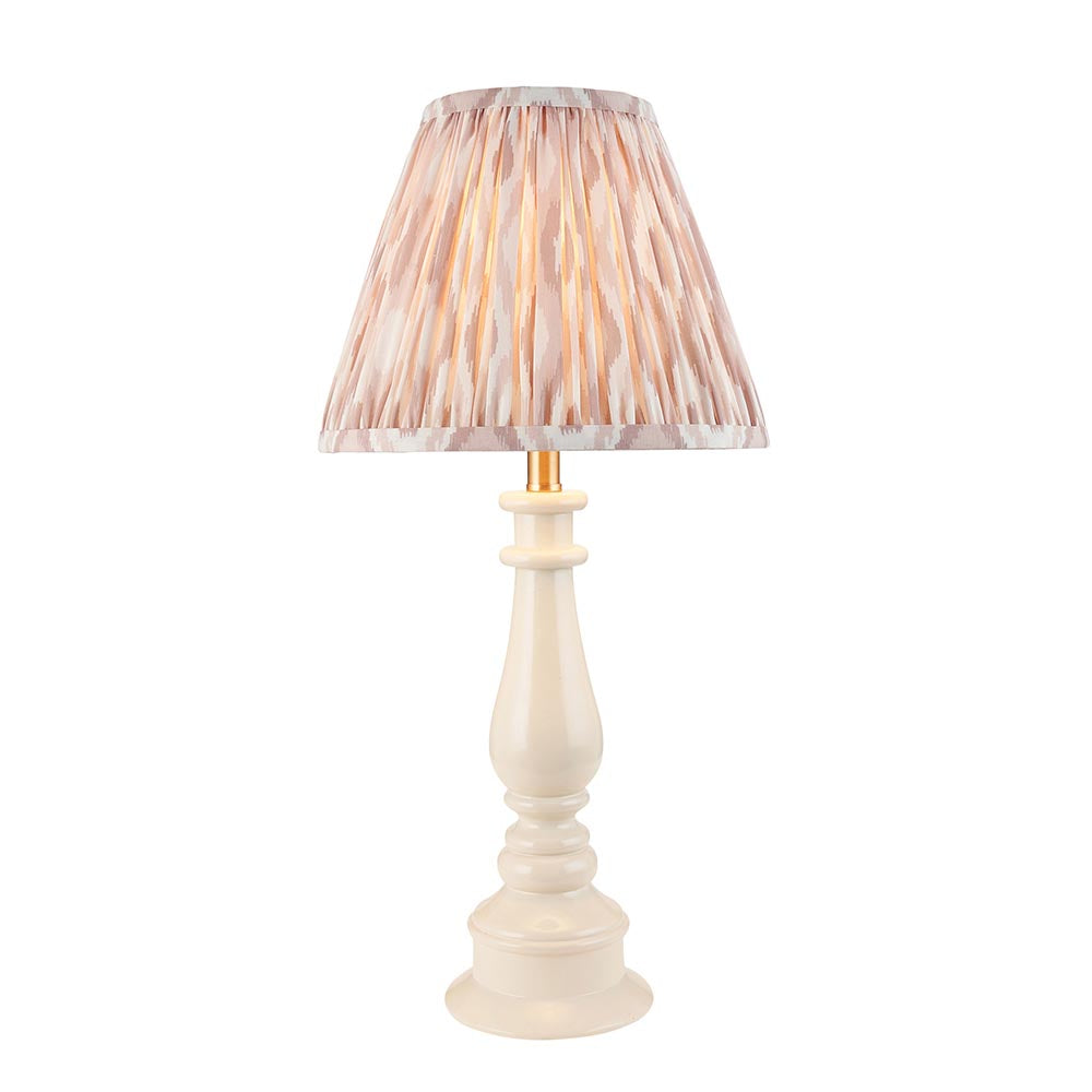 Carlworth Ikat table lamp with turned almond resin spindle base and pleated neutral Ikat shade, brass fittings, on a plain white background.
