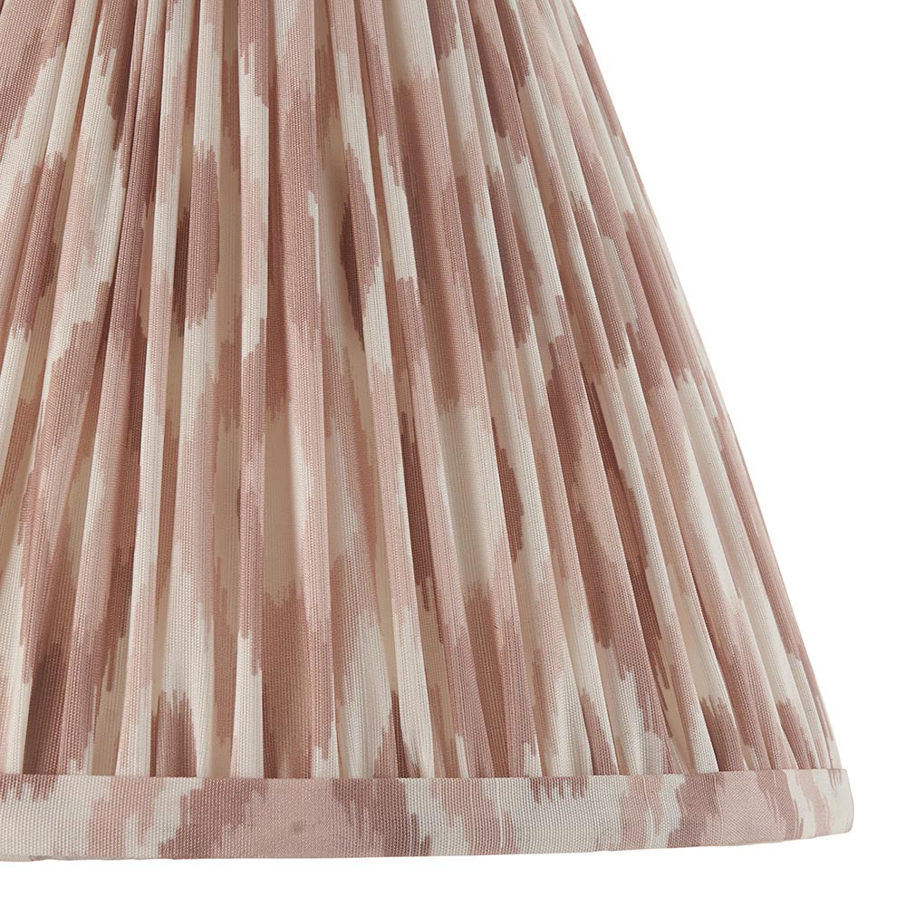 Close-up of the Carlworth Ikat Table Lamp's pleated shade, showing an almond and neutral ikat print with fine vertical pleats and braid trim.