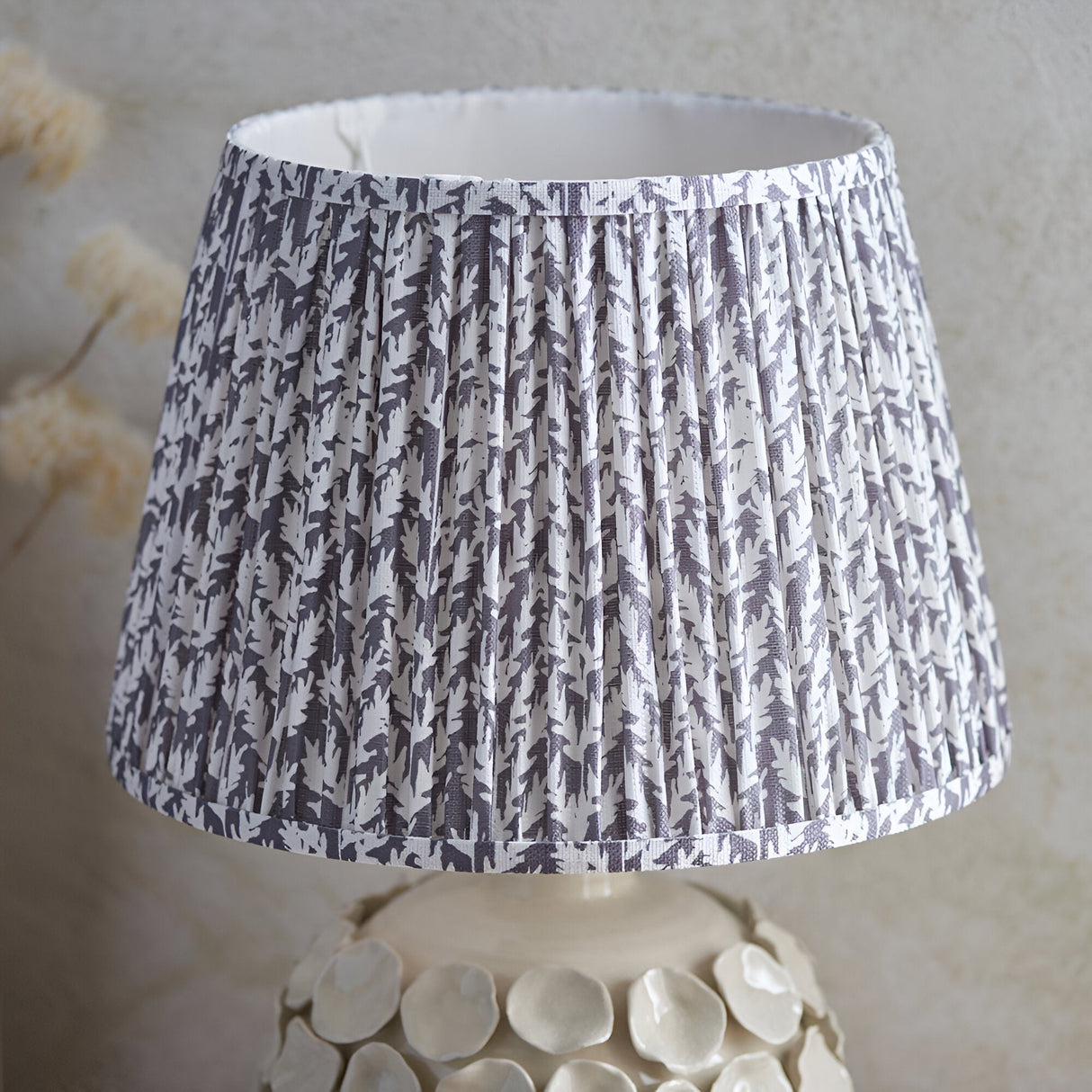 Ashbury Leaf Table Lamp in grey with pleated leaf-print fabric shade on a sculptured ceramic base featuring raised pebble detail.