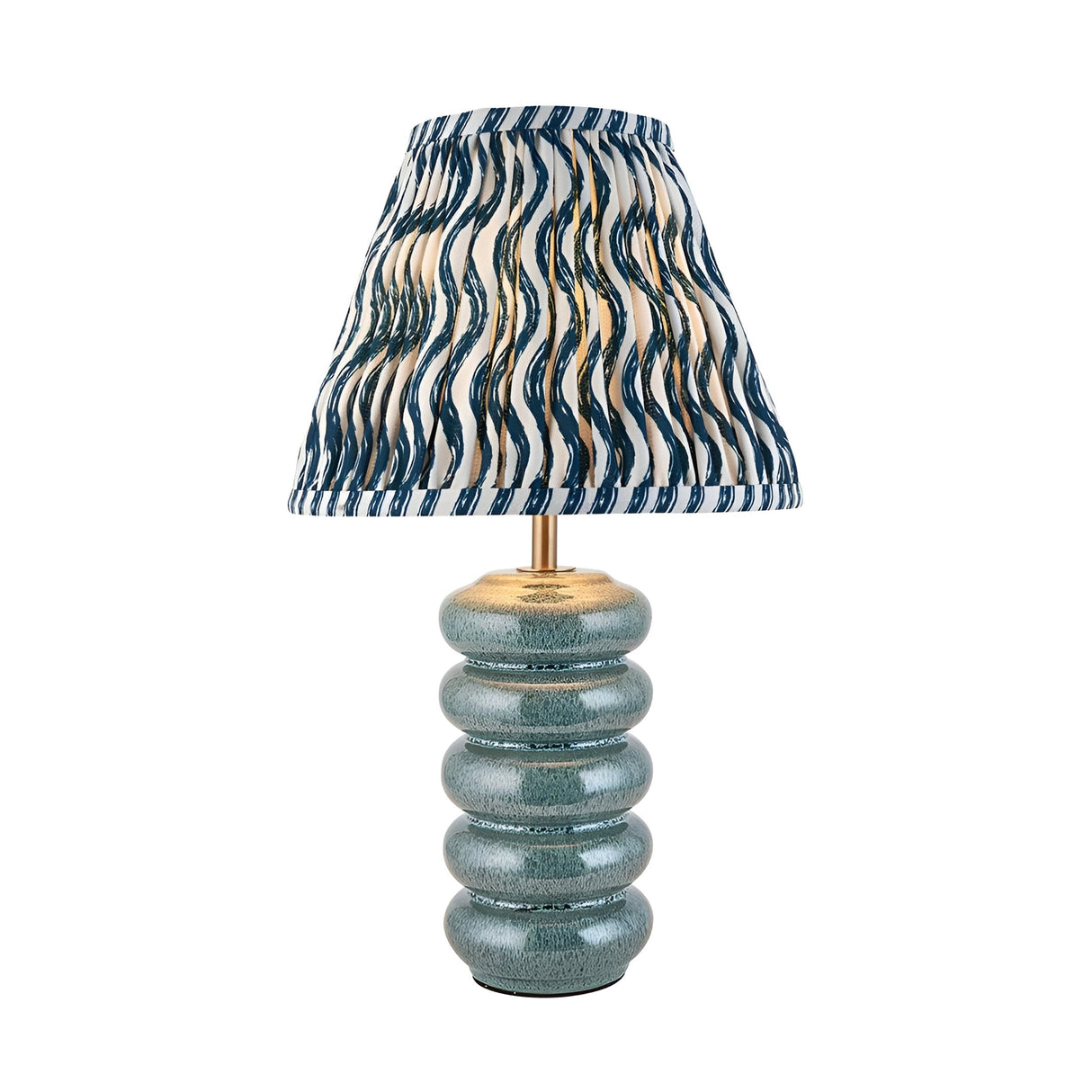 Cliffstead Table Lamp featuring a ribbed ceramic base in blue reactive glaze, brass fittings, and a pleated blue-and-white patterned fabric shade.