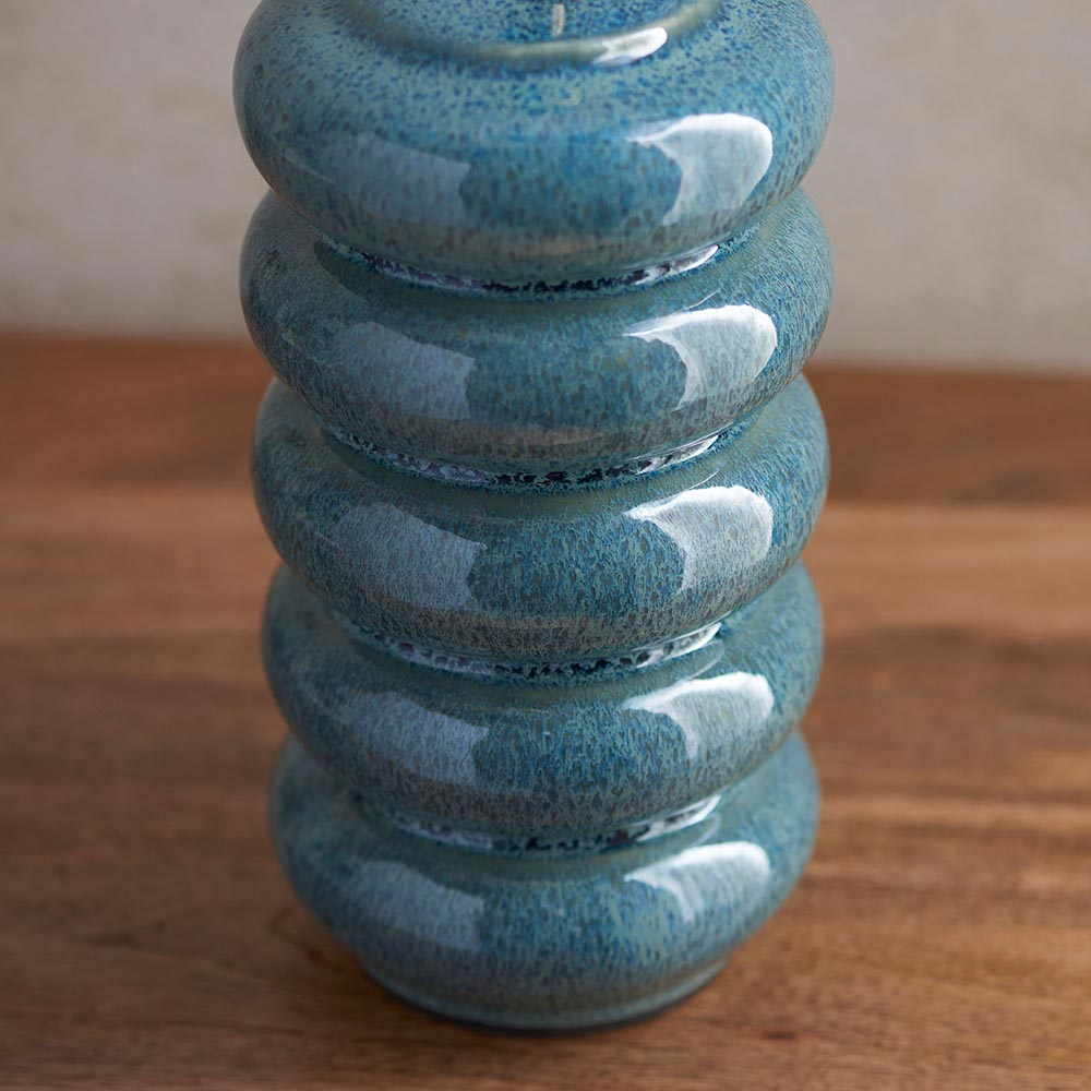 Cliffstead Table Lamp base close-up, ceramic stacked ring design in blue-green reactive glaze, shown on a wooden surface.
