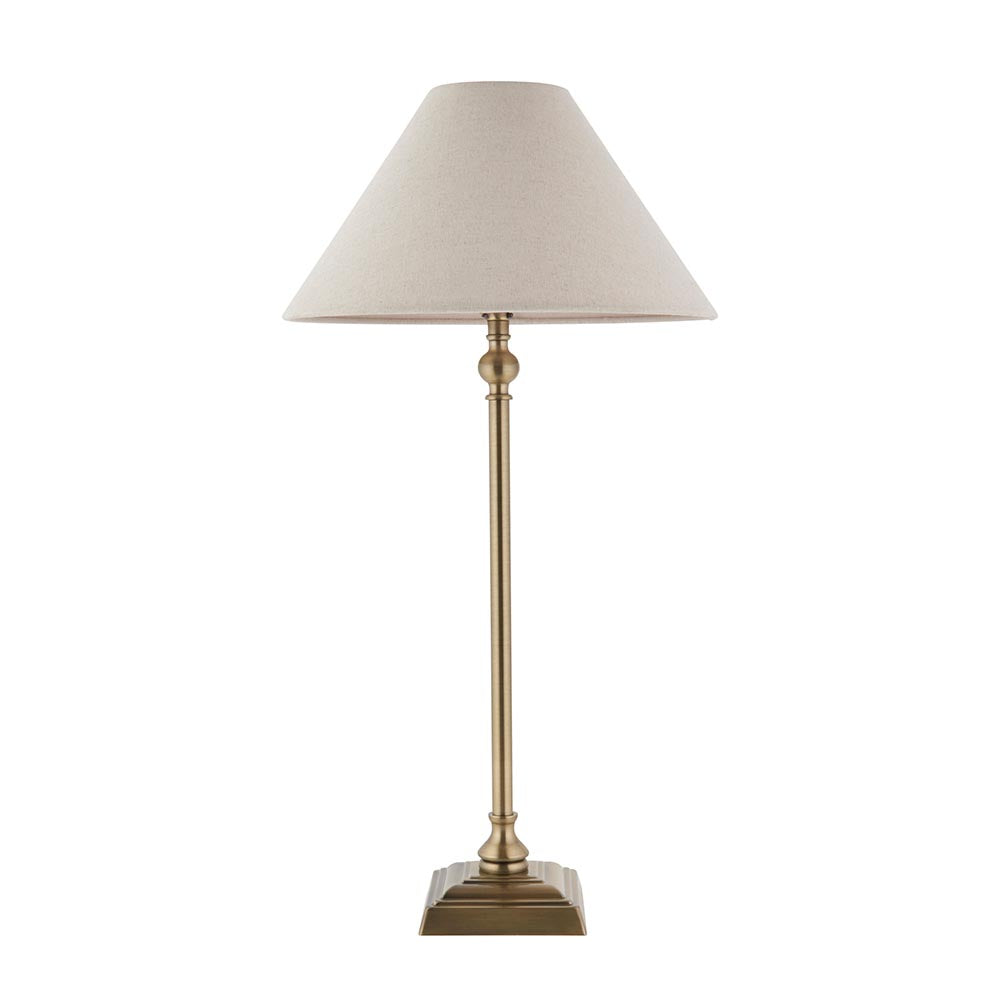Caldmont Table Lamp in brass with a turned metal column, square base, and tapered natural linen shade on a plain white background.