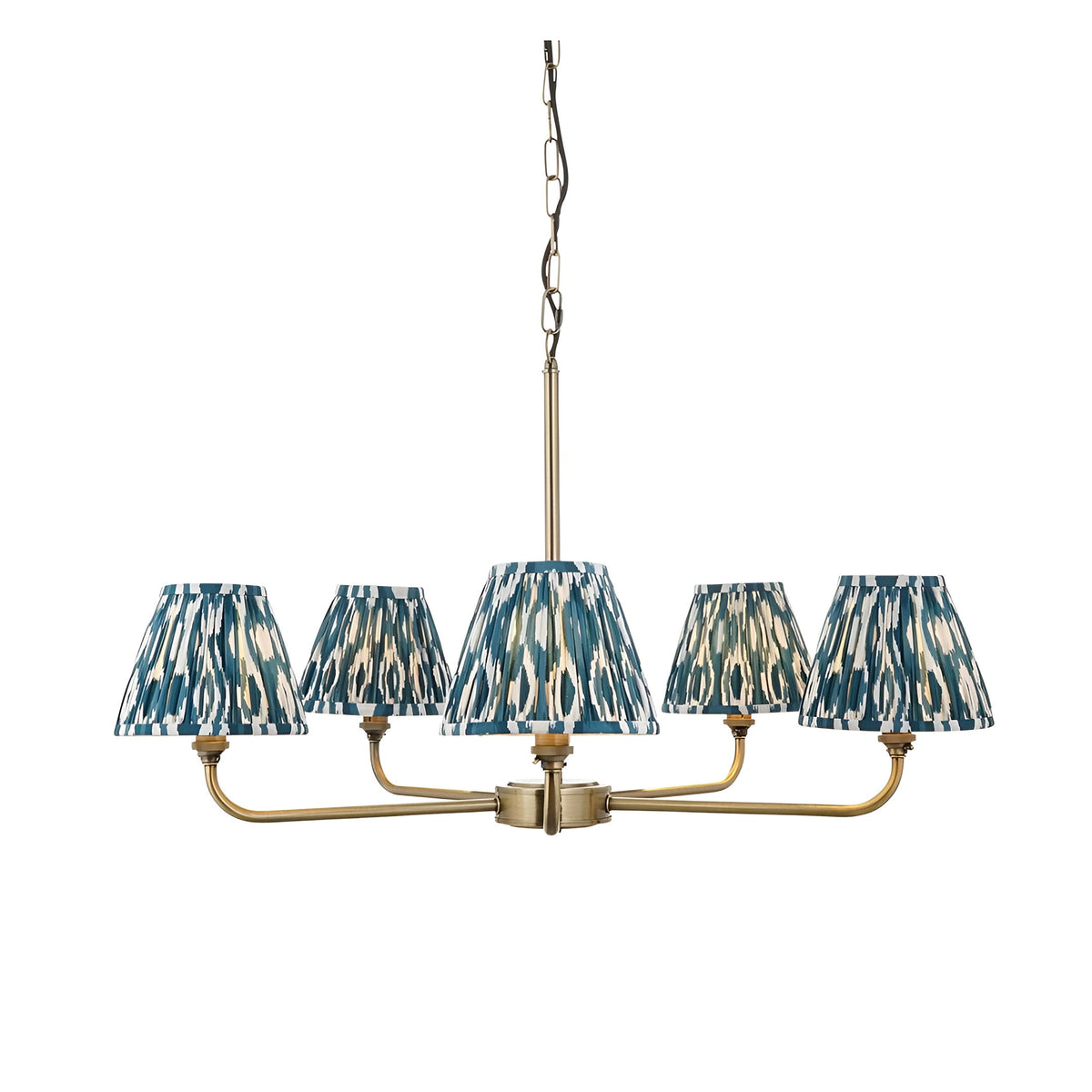 Endon Caldmere five light pendant with tapered pleated ikat shades in marlin blue on antique brass arms, suspended from a chain on a white background.