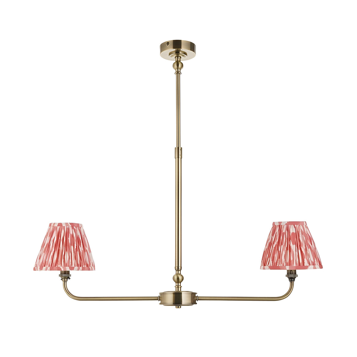 Endon Caldmere 2 light pendant with antique brass linear frame, telescopic stem and two tapered coral ikat pleated fabric shades on a white background.