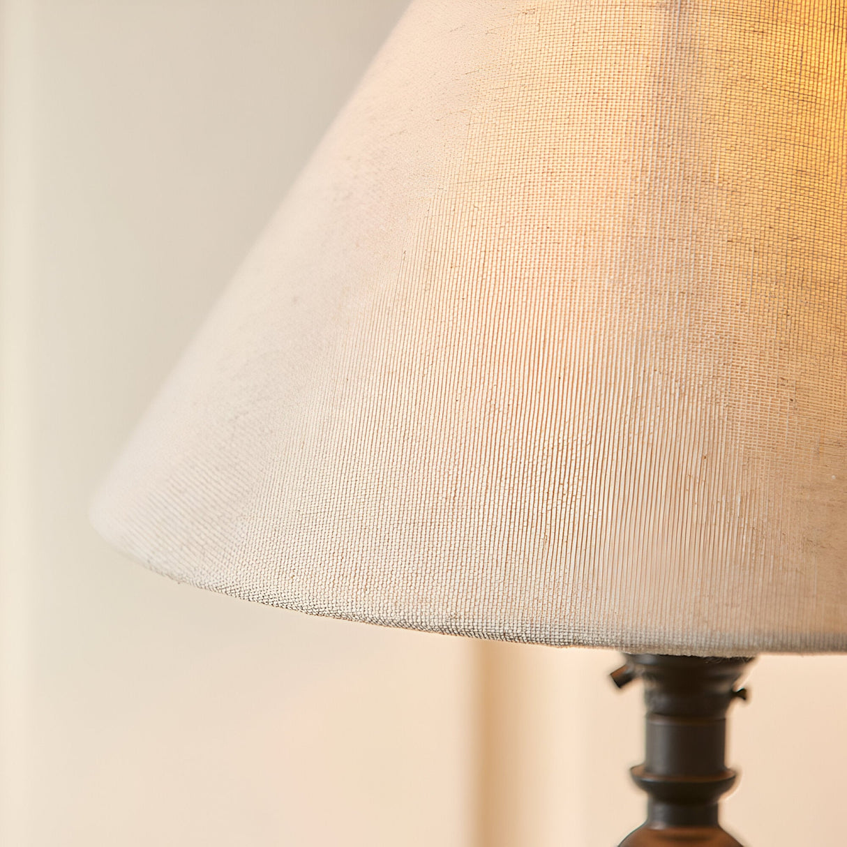 Close-up of the Endon Caldmont table lamp's tapered natural linen mix shade above a matt black candlestick-style column.