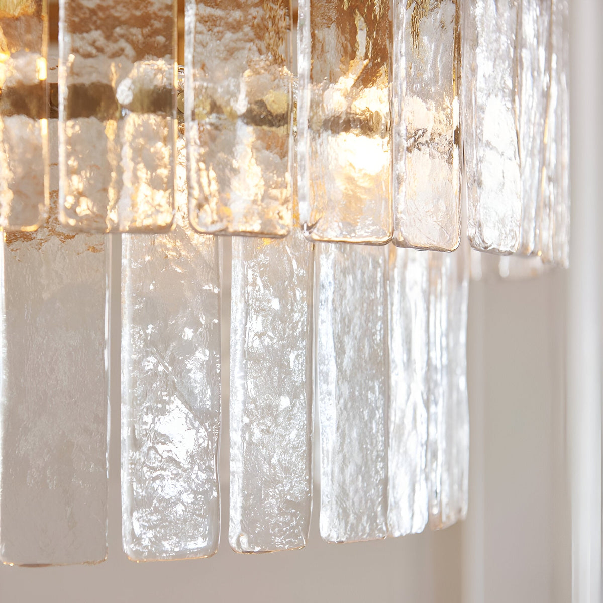 Close-up of Endon Brockhurst 5 Light Chandelier showing two tiers of handmade textured glass panels with brushed aged brass fittings.