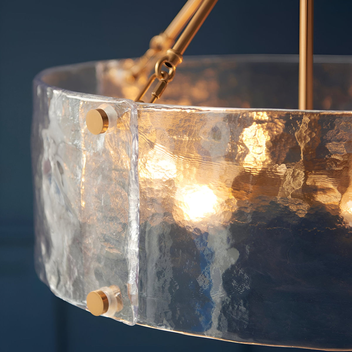 Close-up of Endon Brockmont 6 Light Pendant in brass, showing rippled handmade glass cylinder shade with brass fixings and illuminated E14 lamps within.