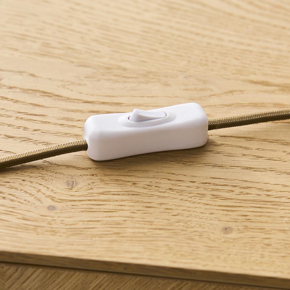 Endon Brockbourne inline on/off switch in white plastic on a taupe fabric flex, resting on a light oak wood surface.