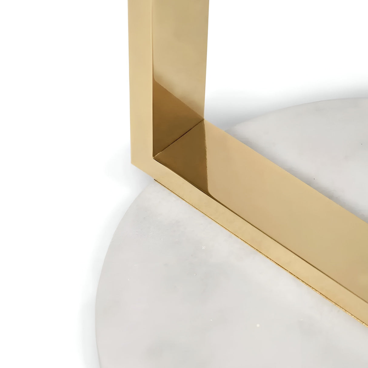 A close-up of the Atria LED Small Alabaster Floor Lamp’s brushed brass frame meeting a round alabaster surface, highlighting its modern, minimalistic design.