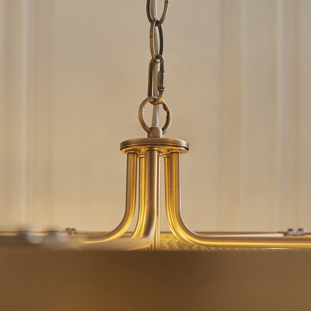 Close-up of Endon Chatsworth 5 Light Pendant showing antique brass central hub, curved arms and grey fabric cable on adjustable chain.