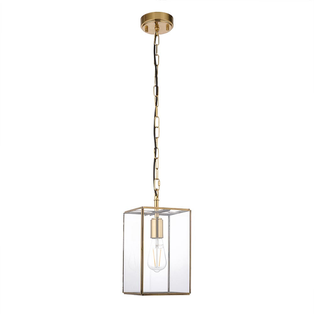 Haddon Pendant in brushed brass with a square lantern frame, clear glass panels, and exposed E27 bulb, suspended from a brass chain on a white background.