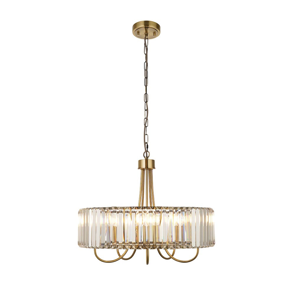 Fairfax 5 Light Pendant in antique brass, with a round drum of faceted crystal glass panels, curved arms, and a chain suspension on a plain white background.