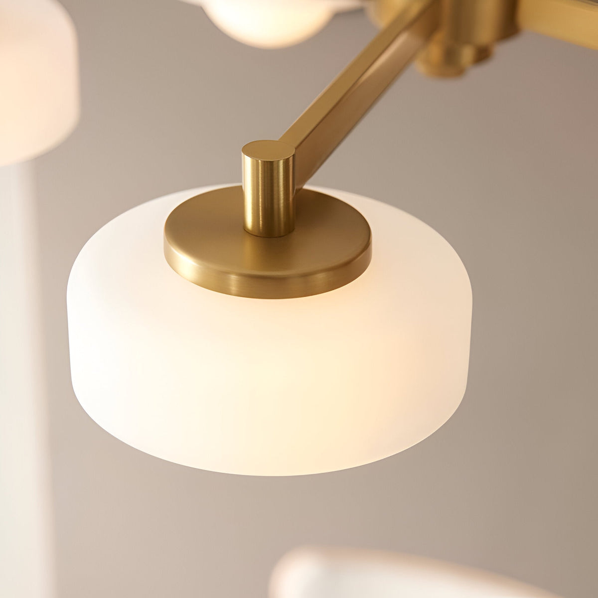 Close-up of Endon Ashby 5 Light Pendant in brushed aged brass, showing a frosted glass shade with opal inner globe on an angled arm.