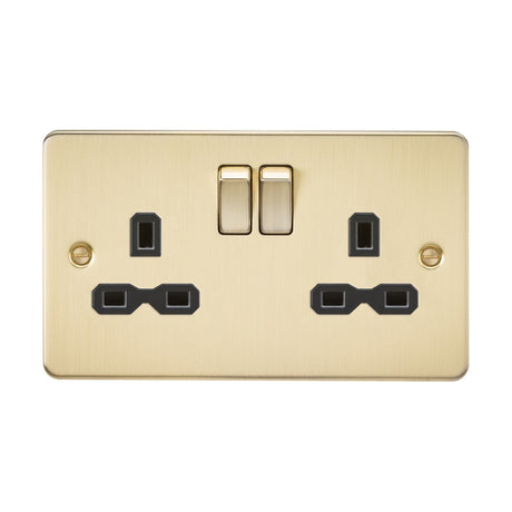 The 13A 2 Gang DP Switched Socket with Twin Earths in brushed brass features a flat plate design and black insert, offering sleek dual electrical connections with a polished finish.