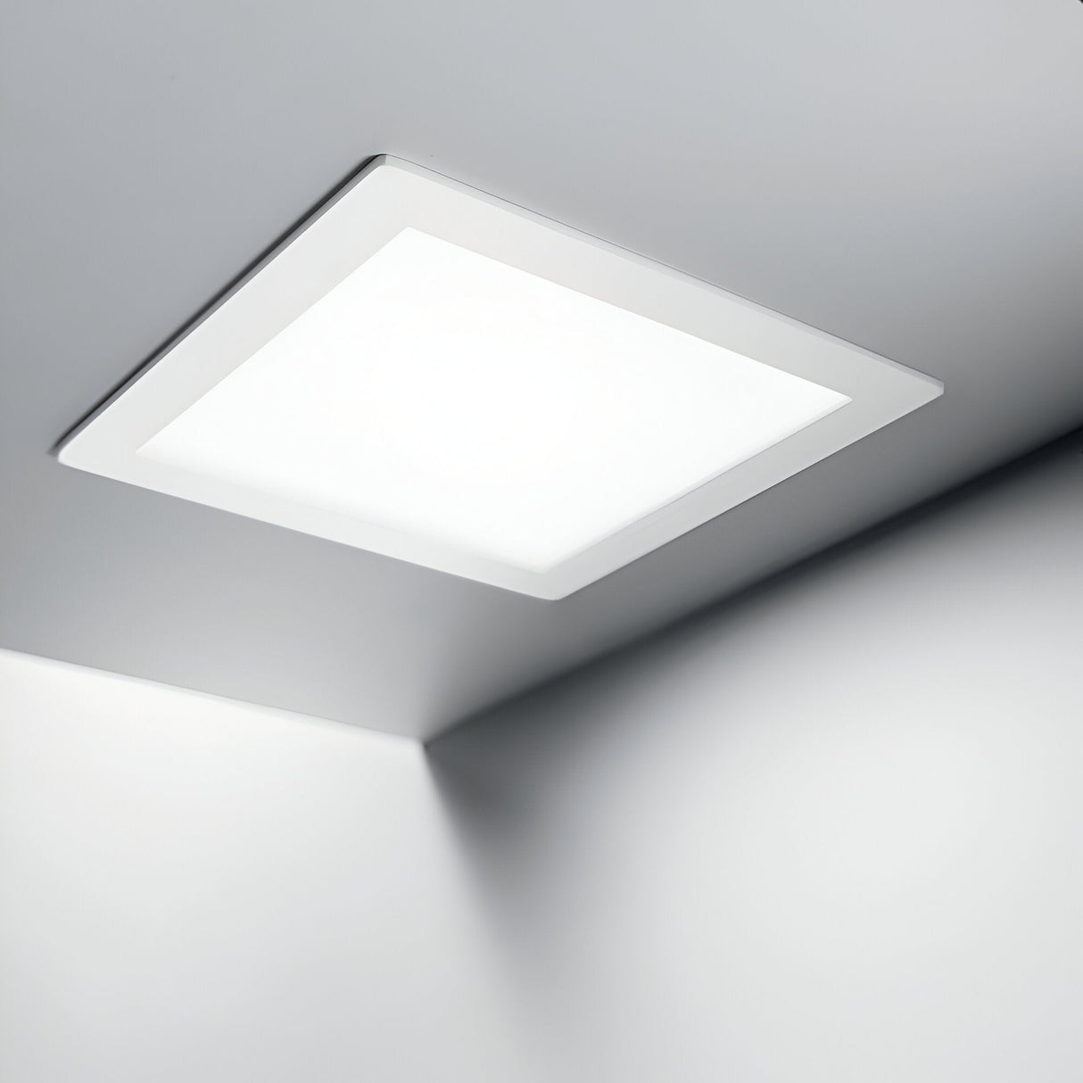 The Focus Square Recessed Downlight - 10W, 3000K, White fills a minimalist room with its warm white glow. Installed discreetly into the ceiling, it distributes soft, even light across the white walls, boosting energy efficiency while contributing to a clean and modern ambiance.