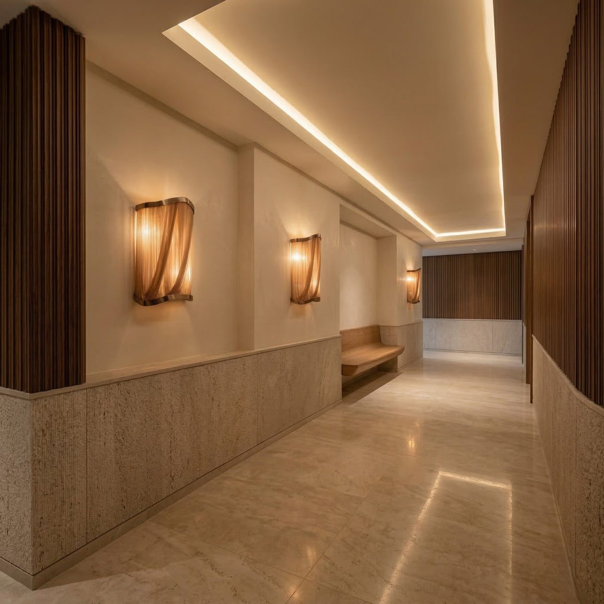 A modern hallway with marble floors, wood accents, and the Mireya 6 Light Metal Chain Veil Wall Light in Champagne exudes understated glamour. A sculptural wall feature and recessed strip lighting enhance the inviting ambiance.