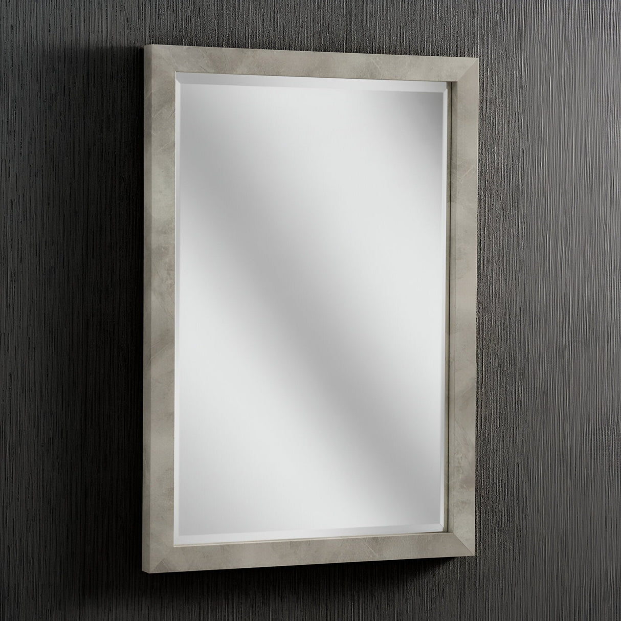 The Echo Rectangle Wall Mirror - Light Concrete, featuring its beige frame, is mounted on a textured dark wall. It reflects a soft, diffused light reminiscent of light concrete finishes, adding a subtle glow and enhancing the industrial design of the surrounding area.
