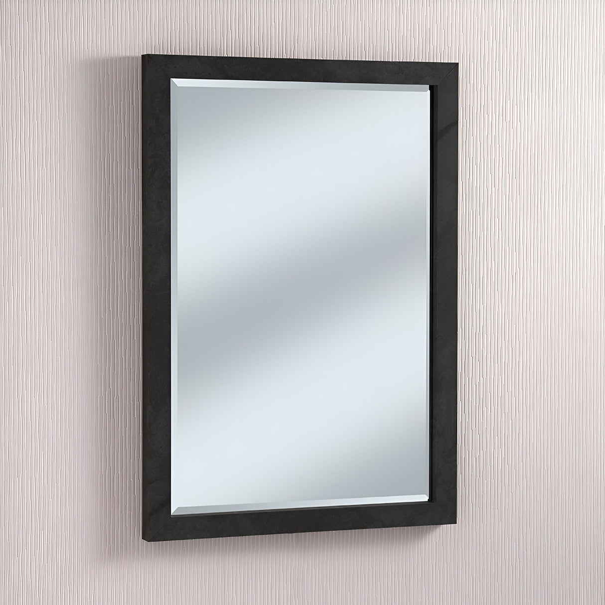 The Eden Rectangle Wall Mirror - Dark Marble, with its elegant frame, adorns a textured light beige wall. This luxurious piece showcases smooth, reflective glass that captures light and shadows from its surroundings, enhancing the ambiance with its subtle sophistication.