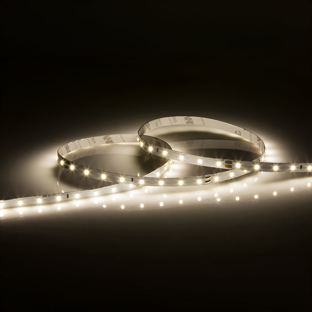 The 24V LED Strip Light 4000K - 1m provides a warm, soft glow in dark settings. This dimmable lighting solution is arranged in a loose circular pattern, featuring small, evenly spaced lights along its length to effortlessly enhance the ambiance.