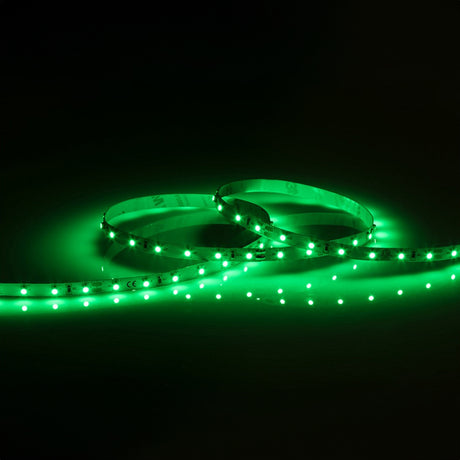 A 24V Green LED Strip Light - 3m is coiled on a dark surface, emitting a vibrant neon glow. Its dimmable feature allows for adjustable brightness, with evenly spaced dots creating a continuous illuminated effect.