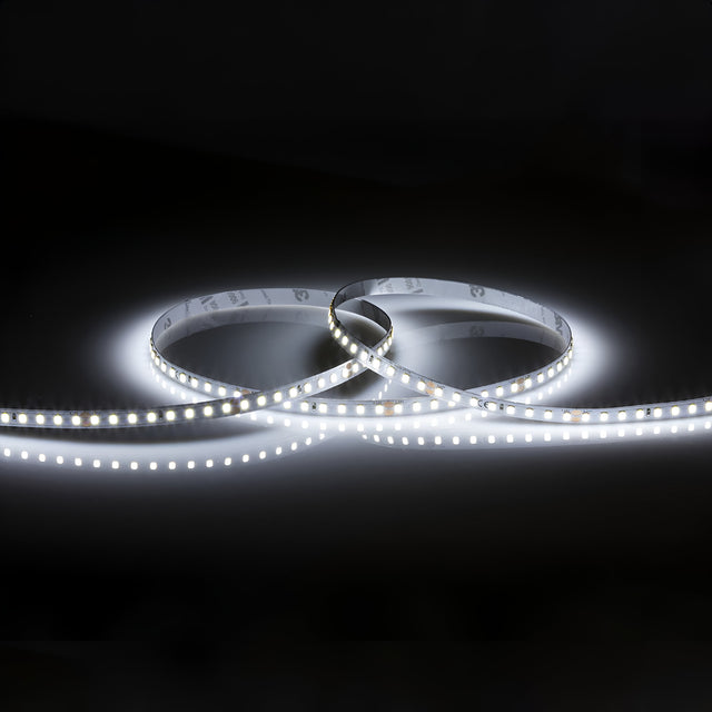 The 24V High Lumen LED Strip Light 6000K - 1m forms a loop against a dark background, emitting a bright white luminescence. The evenly spaced LEDs on the strip produce continuous and vibrant illumination.