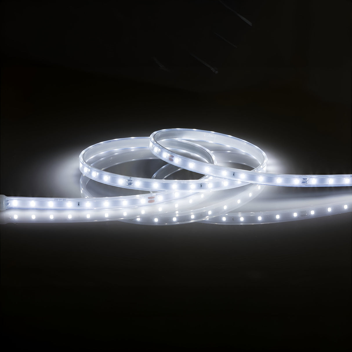 The 24V LED Strip Light IP67 6000K - 5m creates a bright, cool white glow against a dark backdrop. With its evenly spaced individual lights along the flexible strip, this product showcases a sleek and modern design and offers IP67-rated protection for enhanced durability in diverse environments.