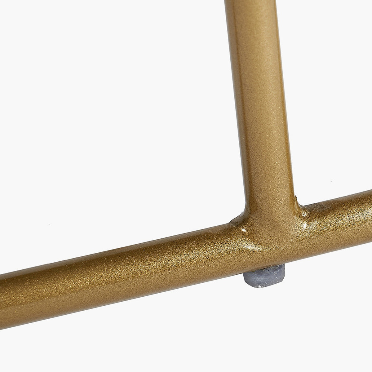 Close-up of the Nino Black Velvet & Gold Iron Bench leg joint, showing gold tubular metal frame with welded T-joint and rubber foot on a plain white background.