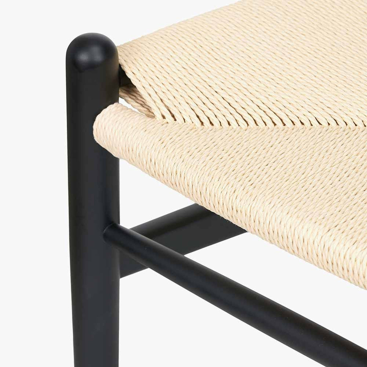 Close-up of the Quinn Black Beech & Paper Rope Dining Chair, showing black wood frame joints with woven natural paper rope seat detail on a plain white background.