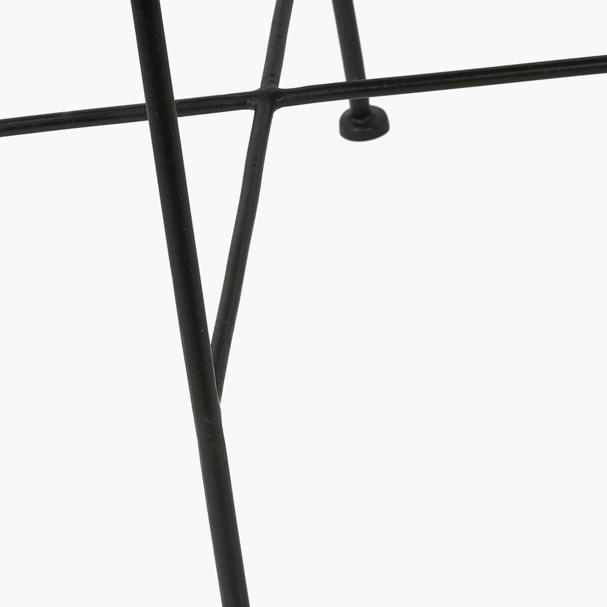 Close-up of the Black Rattan Core & Iron Dining Chair’s metal leg frame, showing crossed black iron supports against a plain white background.
