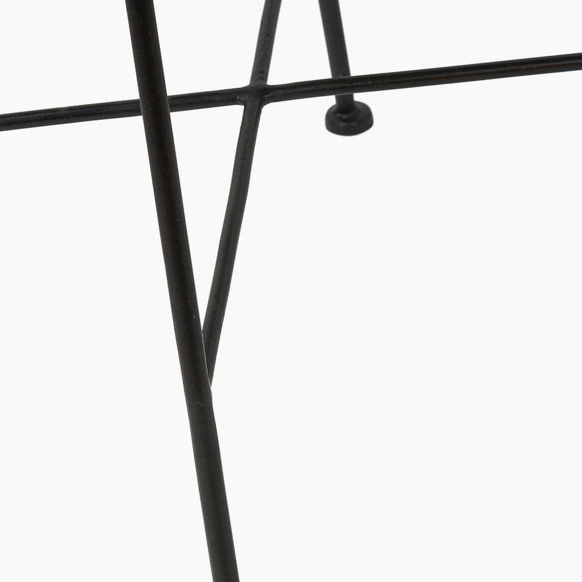 Close-up of the Rattan Core & Black Iron Dining Chair leg base, showing crossed black metal frame joints against a plain white background.