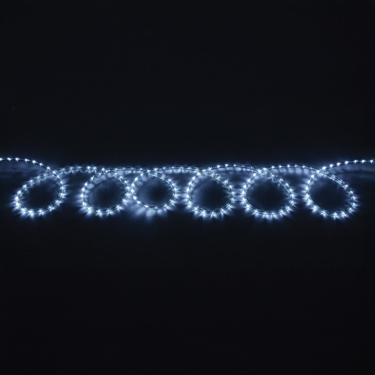 A string of LYYT 230V IP44 LED Rope Light 50m - 5000K is arranged in looped circles against a dark background, creating a cool white, glowing pattern.