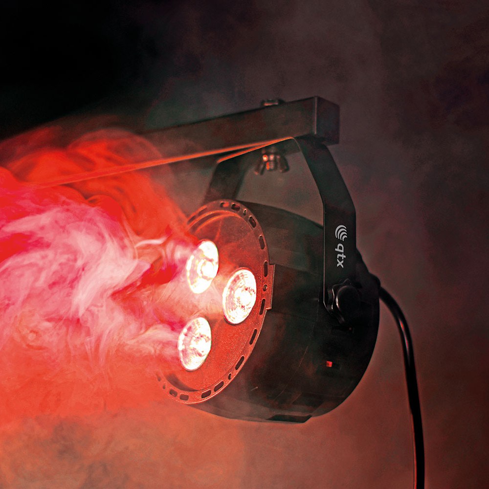 QTX 3x4W Mini Par Light RGBW by AVSL, matte black moulded housing with three LEDs casting red light through haze, mounted on tilt bracket.