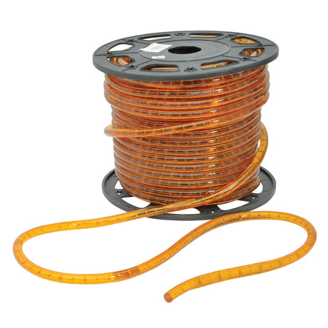 A one-meter length of the LYYT 230V IP44 LED Rope Light in orange, designed for weather resistance, is neatly wound around a black plastic reel, with a segment extending gracefully across the floor.